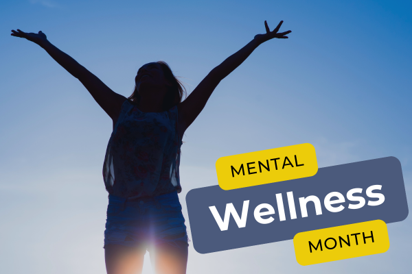 January is Mental Wellness Month. Image of a person standing in front of sunlight it their arms stretched out toward the sky